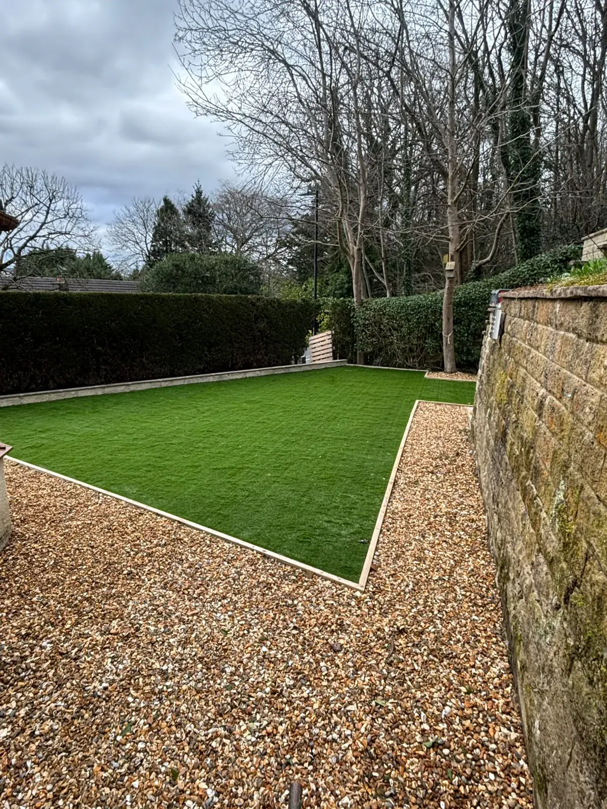 Artificial grass stone boundary completed by Crown Hill Contracting