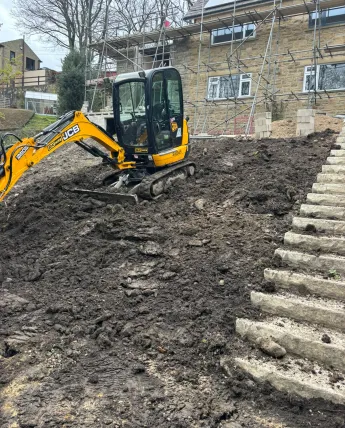 Excavated garden slope prepared for a flight of new stone steps