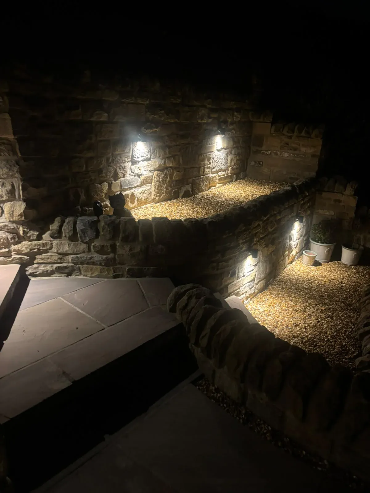 Illuminated stone retaining walls completed by Crown Hill Contracting