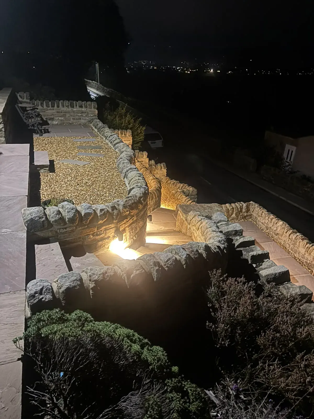 Landscape lighting stone garden completed by Crown Hill Contracting