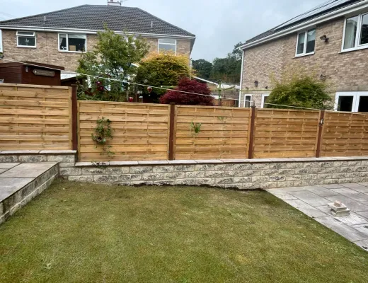 Modern horizontal timber boundary fencing behind a newly landscaped lawn