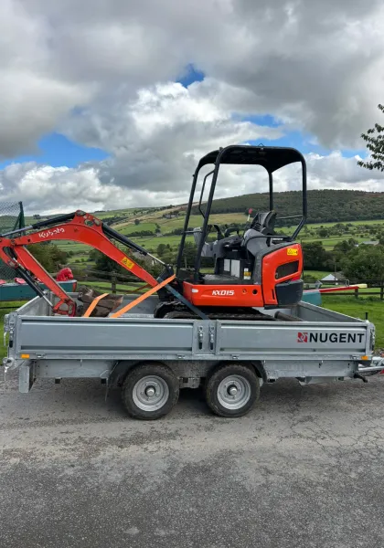 Compact excavator ready for landscaping and groundworks on a rural site