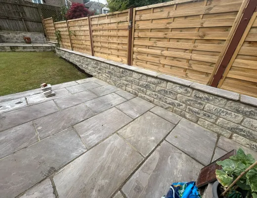 New grey porcelain patio beside a fresh timber boundary fence