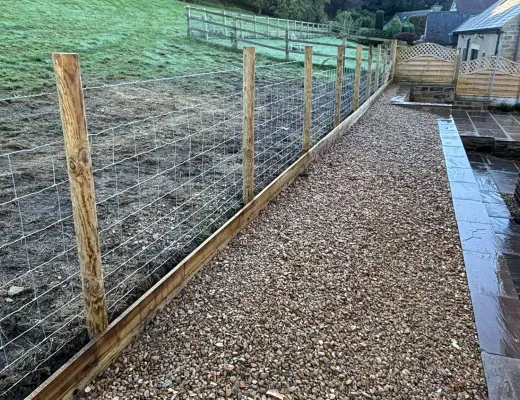 New timber post and wire stock fence beside a gravel garden path