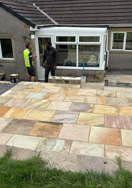 New multi-coloured sandstone patio across the rear of a Yorkshire home