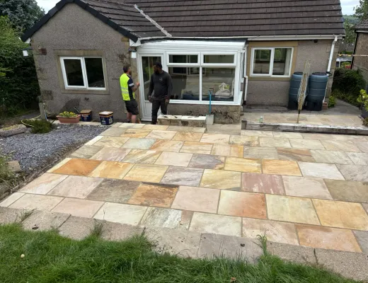 New multi-coloured sandstone patio laid across the rear of a Yorkshire home