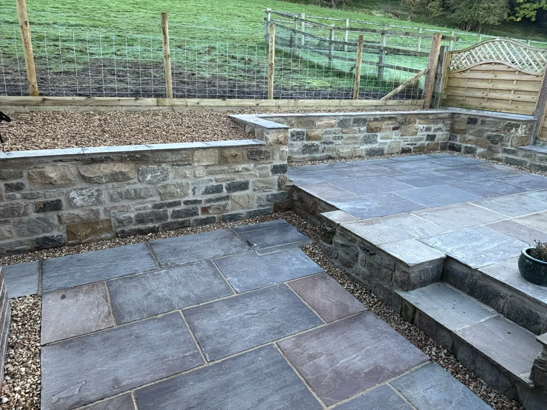Slate patio retaining wall steps completed by Crown Hill Contracting