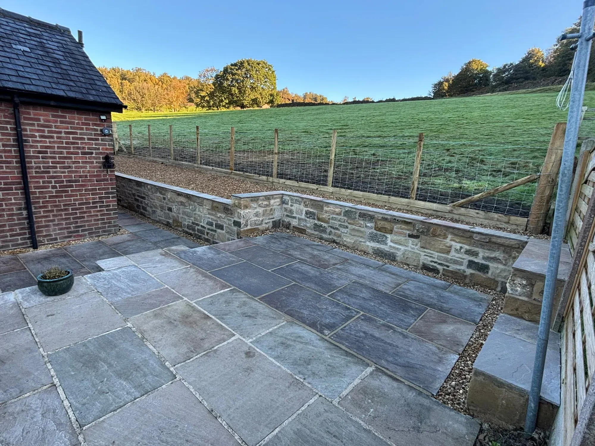 Slate patio stone retaining wall completed by Crown Hill Contracting
