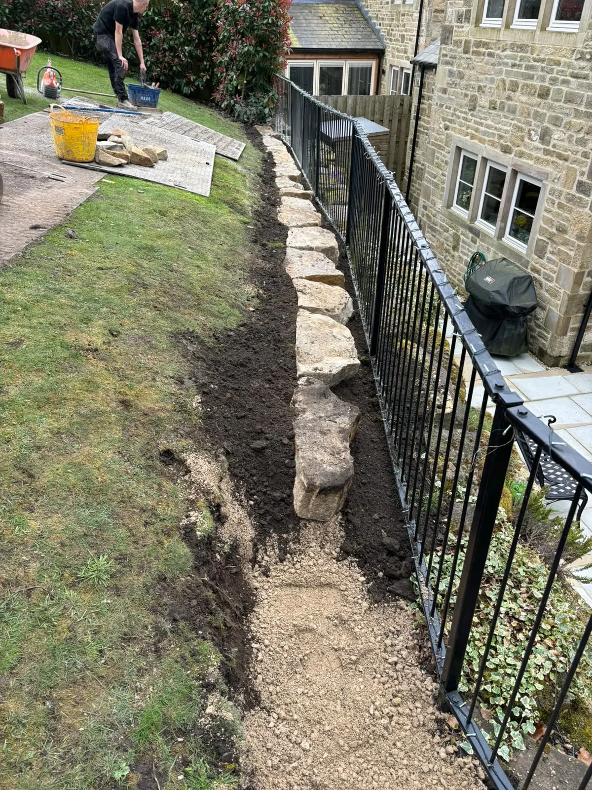 Stone retaining wall trench completed by Crown Hill Contracting