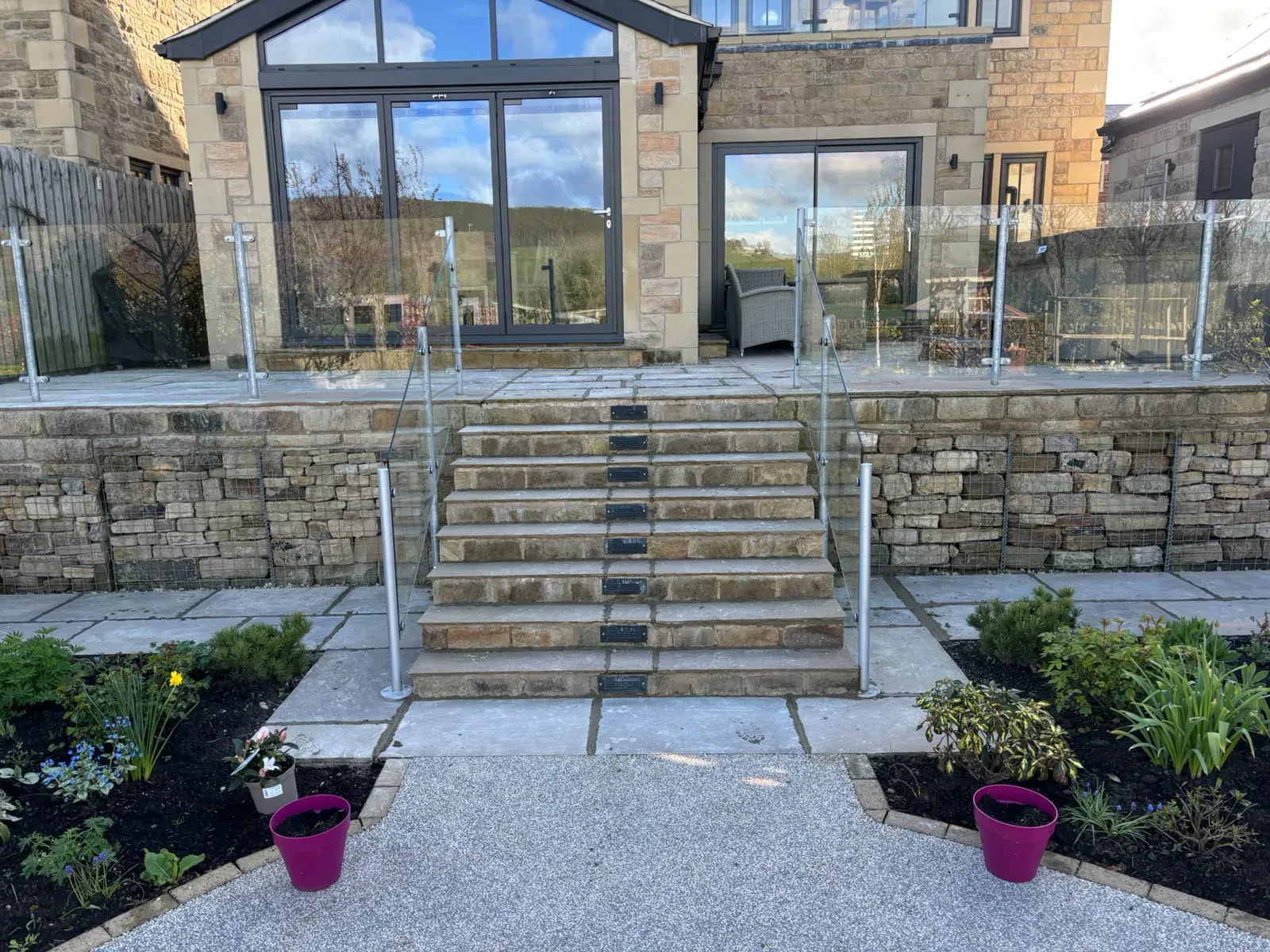 Stone steps glass balustrade close completed by Crown Hill Contracting